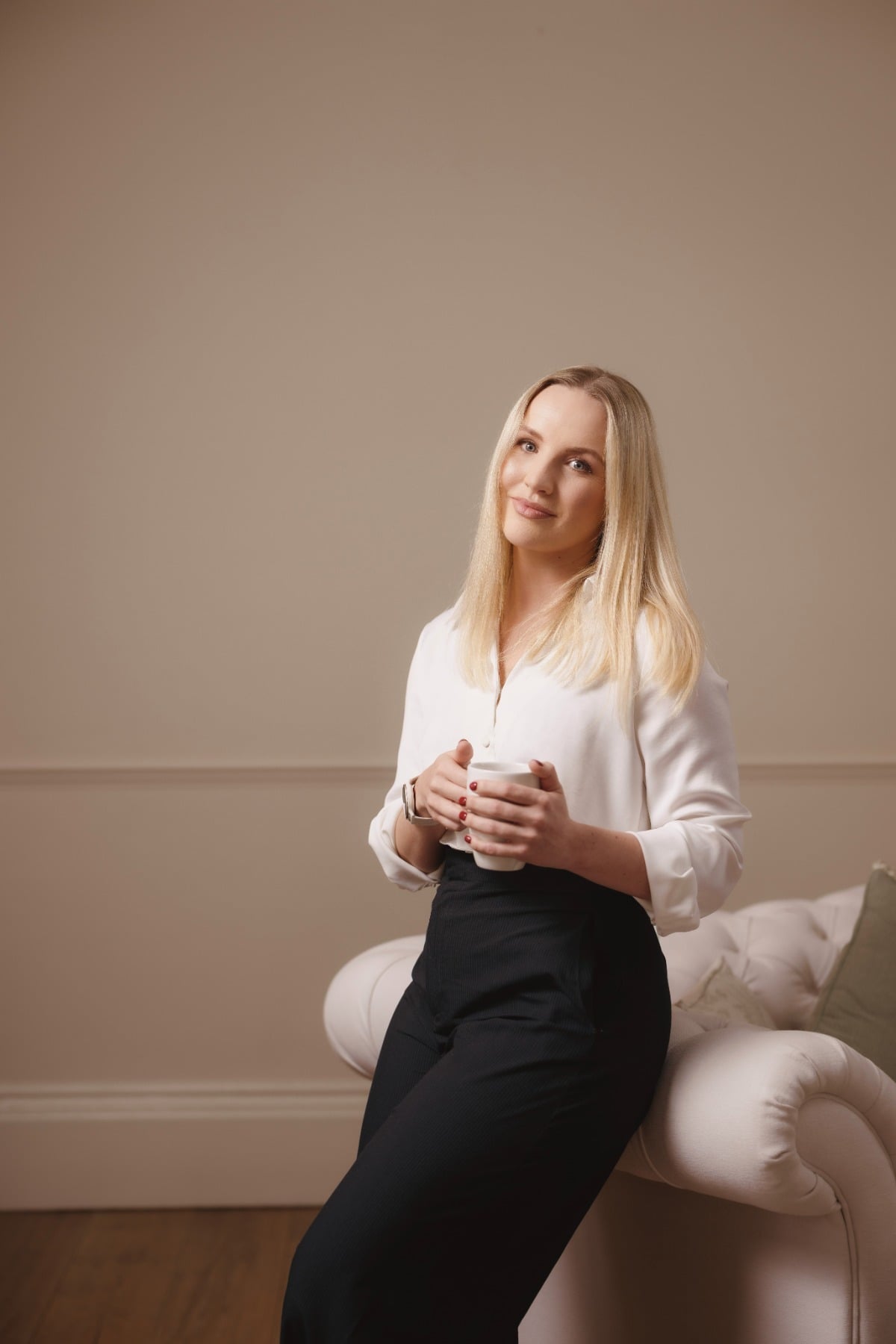 Rachel Turnbull, CBT therapist in Norwich, holding a coffee and looking to camera